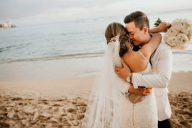 Wedding couple embrace on the beach